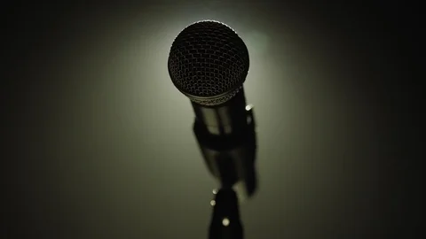 Close-up of microphone on stage with white lighting and smoke. Stock Footage 125082554