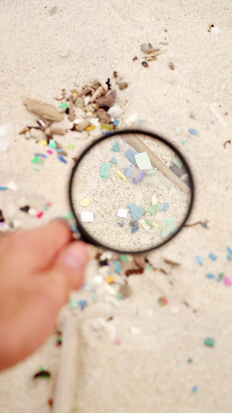 Close-up, microplastics in sand on beach, ocean plastic pollution Stock Footage 306723759