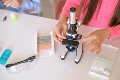 Close-up of a microscope and glass with sample cells for examination. Stock Photos