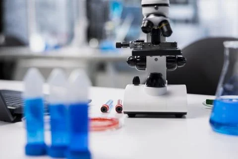 Close up of microscope and test tubes used for studying cellular structures Stock Photos
