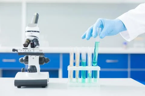 Close up of a microscope standing near test tubes Stock Photos