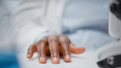 Close up of microscopist studying genetic tissue sample on petri dish Stock Photos