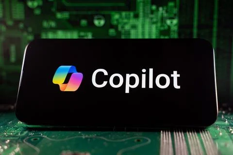 Close up of Microsoft Copilot logo on device with circuit board background. Stock Photos