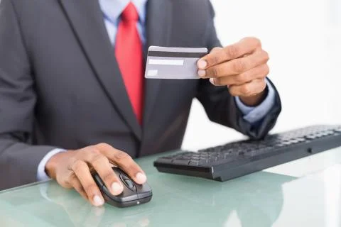 Close up mid section of a businessman doing online shopping Stock Photos