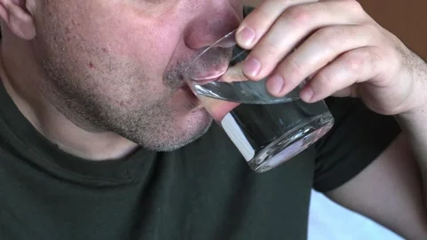 Close up middle age man drinking water from glass at home Video stock 301893177