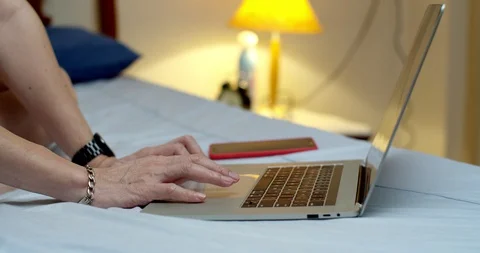 Close up of middle age man hands using smartphone and typing on notebook keyb Stock Footage 128483983