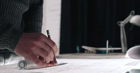 Close up of Middle Aged Architects Hands making important Blueprints at his Stock Footage 139240669
