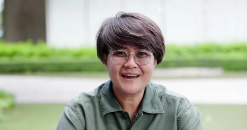 Close up of middle-aged Beautiful Asian woman short hair talking with confidence Stock Footage 163661644