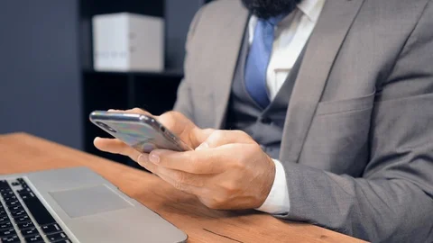 Close up middle aged businessman using smartphone in office Stock Footage 118226763