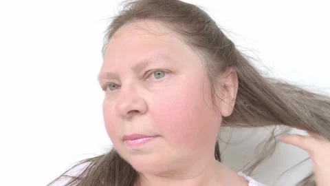 Close up middle-aged female face, brown-haired woman 50-55 years old examin.. Stock Footage 248163037