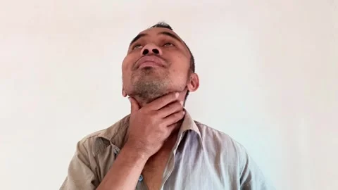 Close-up of a middle-aged man holding his throat. Stock Footage 321940705