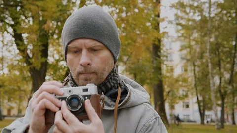 Close up middle-aged man with retro photo camera. Stock Footage 129351633