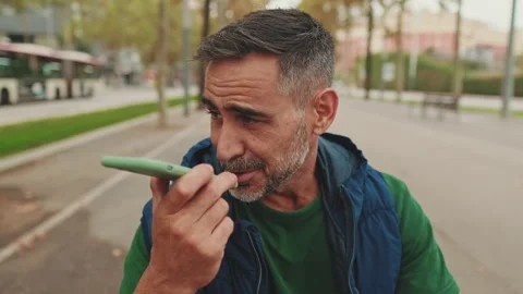 Close up, middle-aged man sends voice message from smartphone Stock-Footage 242955618