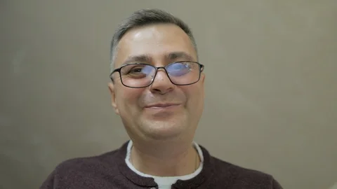 Close-up of a middle-aged man who bends down and talks tenderly, gesturing with Stock Footage 112429336