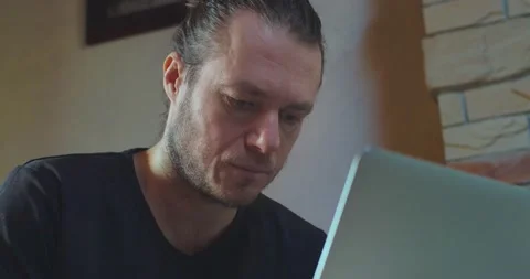 Close up middle-aged man working on laptop seriously looking on screen indoors Stock Footage 150810583