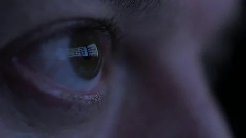 Close up of middle aged man's eyes while surfing internet at night Vídeo Stock 69887596