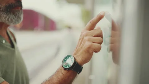 Close-up of middle-aged man's hand runs with his finger on city transport Stock Footage 227033571