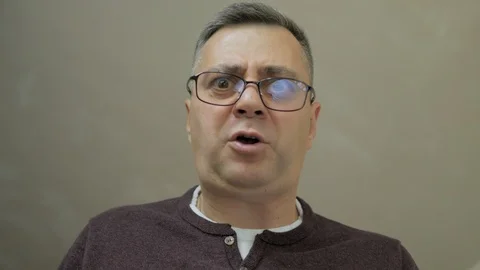 Close-up of middle-aged men, which stoops down and yells and screams Stock Footage 112426896