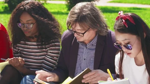 Close-up of middle-aged professor reading textbook aloud Stock Footage 93247655