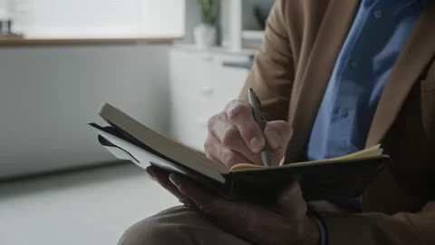 Close-Up of Middle Aged Therapist Writing Notes in Notebook in Office Stock Footage 340636172