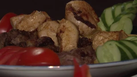 Close-up of middle eastern platter of kebab, potatoes, hummus, salad, pita. Stock Footage 88866235