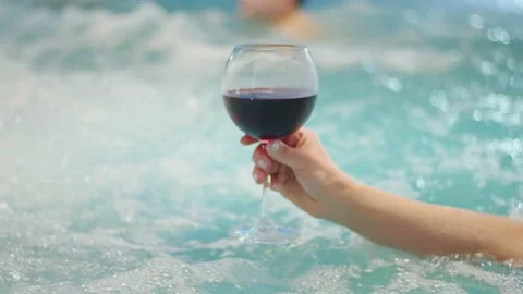 Close up In the midst of her vacation, a young woman relaxes in the pool Stock Footage 236722283