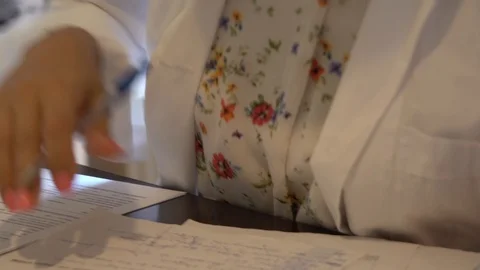 Close up of midwife hands going through exams Stock Footage 113347962