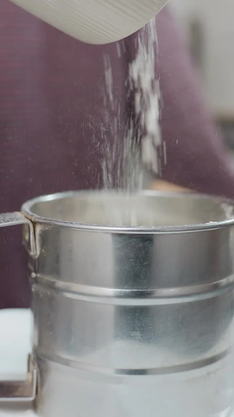 Close-Up of Milk Being Poured into Stainless Steel Cup for Baking Preparation Stock Footage 320338829