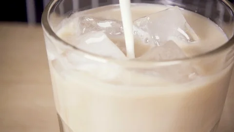 Close-up Milk is poured into the ice Stock-Footage 87980684