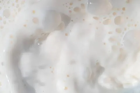Close-up of milk splash with bubbles and foam Stock Photos