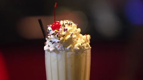 Close up of a Milkshakes with cherry and whipped cream Stock Footage 273013904