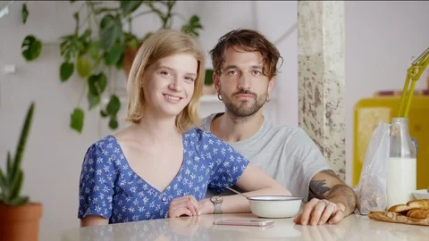 Close up of millennial couple smiling with joy at good morning in modern dining Stock Footage 108797086