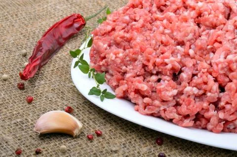 Close-up of minced  meat with pepper,  thyme and garlic Stock Photos