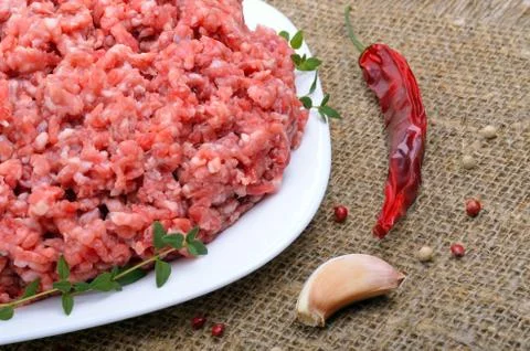 Close-up of minced  meat with pepper,  thyme and garlic Stock Photos