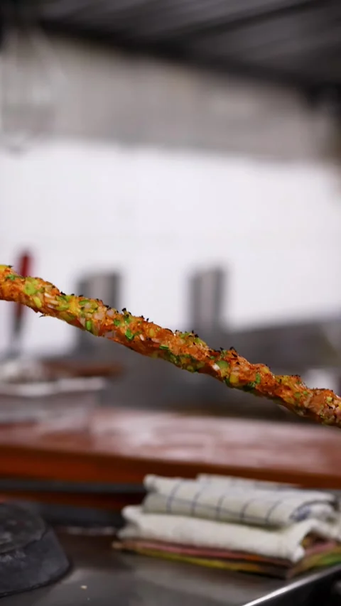 Close Up of Minced Meat Seekh Kebab Cooking on Metal Skewer Stock Footage 340194556