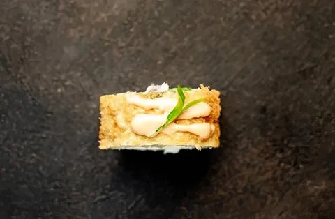Close-up of a mini cake with cream and green garnish Stock Photos