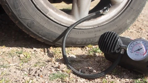 Close up of a mini compressor with pressure gauge which inflates the car tire Stock Footage 124830582