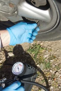 Close up of a mini compressor with pressure gauge which inflates the car tir Stock Photos