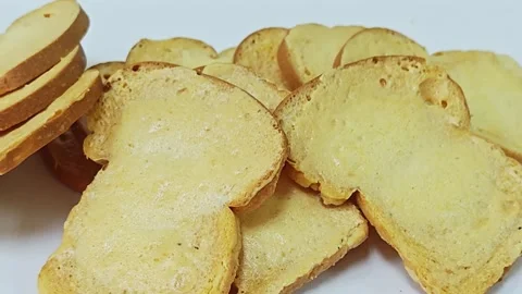 Close up of mini crispy toast rusks stacked on white surface. Stock Footage 339991127