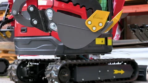 Close-up of a mini excavator digging bucket and mechanical grapple thumb. Video stock 338432188