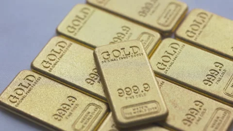 Close-Up of Mini Gold Bars on White Background Stock Footage 327805552
