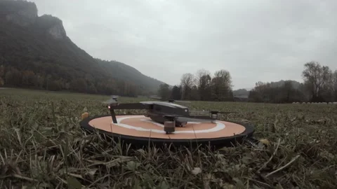 Close Up: Mini Quadcopter Drone Start Flying From Orange Pad. Stock Footage 164953149