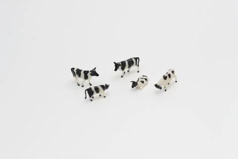 A close up of miniature figures of a herd of cows Stock Photos