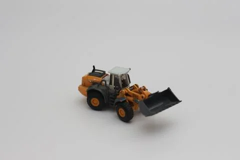 A close up of miniature orange wheel loader toy Stock Photos