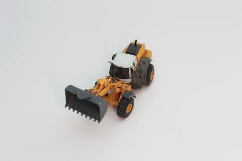 A close up of miniature orange wheel loader toy Stock Photos