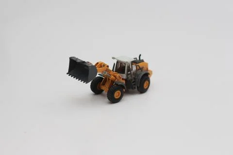 A close up of miniature orange wheel loader toy Stock Photos