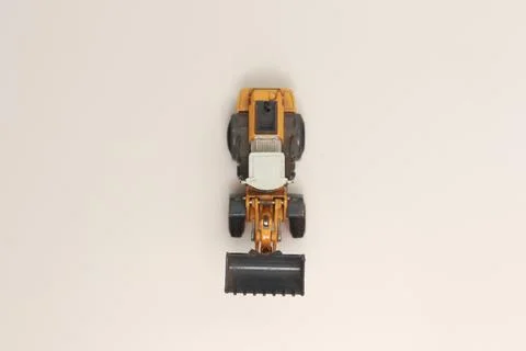 A close up of miniature orange wheel loader toy Stock Photos