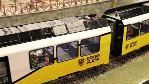 Close-Up Of A Miniature Passenger Train With Tiny Figures Inside The Windows Video stock 302567522