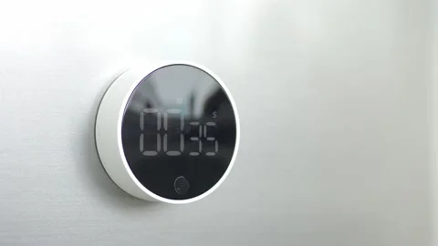 Close-up minimalistic timer chronometer with reverse time response, on white wal Stock Footage 219253476