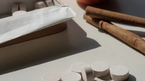 Close-up of mints or Peppermint, an open rectangular tin, cinnamon stick and a Stockbeeldmateriaal 293286608
